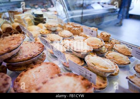 Variety of fresh meat pies in refrigerator at butchers shop Stock Photo