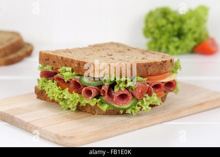 Sandwich toast bread for breakfast with salami, cheese, tomatoes, lettuce Stock Photo