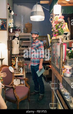 Portrait of stylish mid adult man in vintage shop Stock Photo
