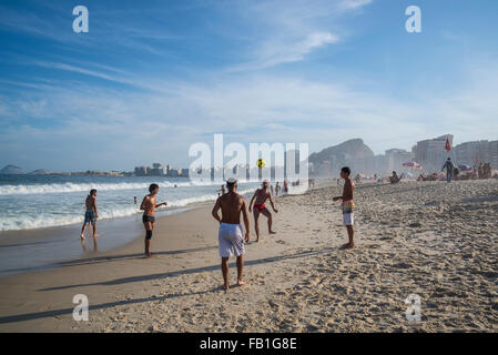Young men playing football, Copacabana beach, Rio de Janeiro, Brazil Stock Photo