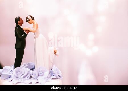 Bride and bridegroom cake decoration on top of wedding cake Stock Photo