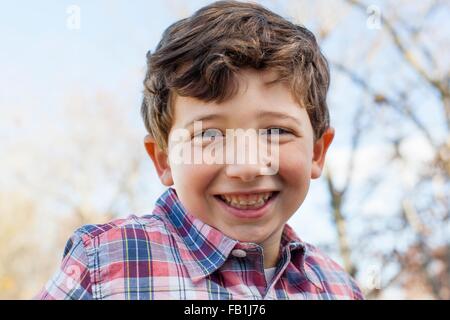 Portrait of boy wearing checked shirt looking at camera smiling Stock Photo