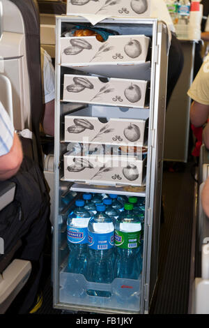 A light snack / snacks food and drinks trolley cart on a Swiss flight between London UK and Geneva Switzerland. Stock Photo