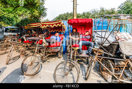 Rickshaw drivers on a break after taking tourist on a tour in the Houhai lakes area Beijing China Stock Photo