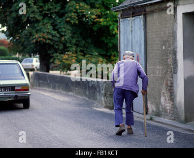 Crooked old man with stick in the Loire area of France Stock Photo