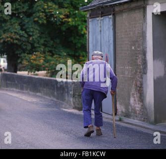 Crooked old man with stick in the Loire area of France Stock Photo