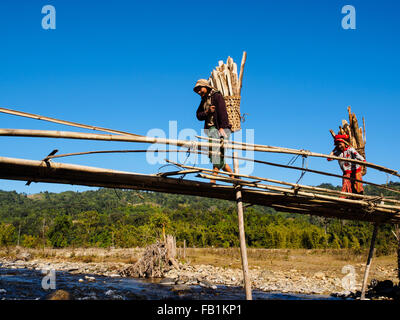 Lisu women carrying firewood collecting from nearby forest. Stock Photo