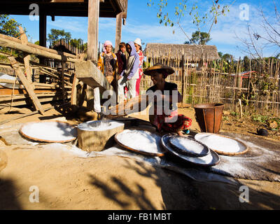 Lisu people pounding rice with wooden mortar. Stock Photo
