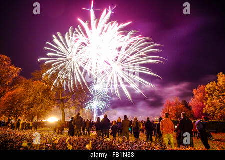 Guy Fawkes night fireworks with a crowd in Elgin, Moray, Scotland, United Kingdom. Stock Photo