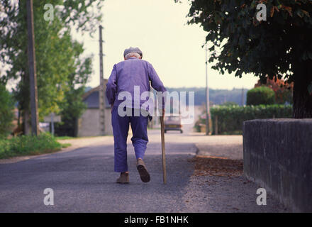 Crooked old man with stick in the Loire area of France Stock Photo