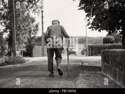 Crooked old man with stick in the Loire area of France Stock Photo