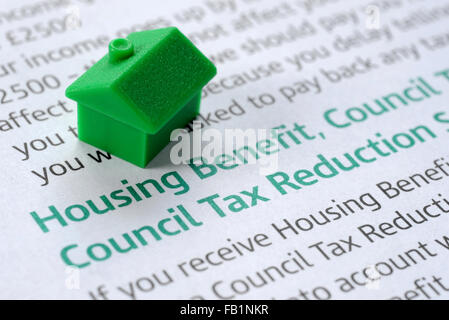 HOUSING BENEFIT INFORMATION LEAFLET WITH MODEL HOUSE RE BENEFITS INCOMES WAGES COUNCIL TAX REDUCTION FAMILY CLAIM FORM WAGES UK Stock Photo