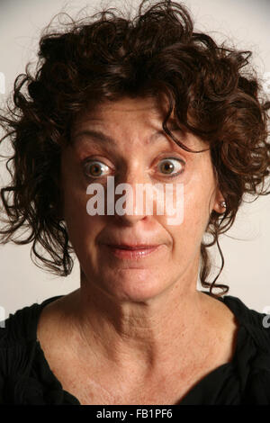 An adult woman imitates the expressions of a baby. Stock Photo