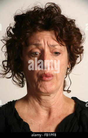 An adult woman imitates the expressions of a baby. Stock Photo