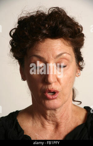 An adult woman imitates the expressions of a baby. Stock Photo