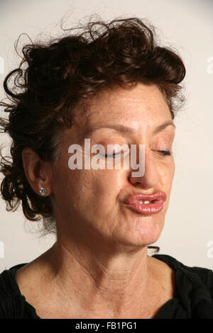 An adult woman imitates the expressions of a baby. Stock Photo