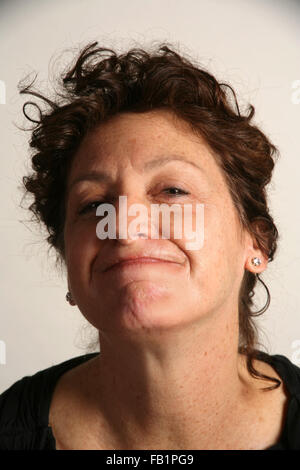 An adult woman imitates the expressions of a baby. Stock Photo