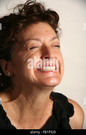 An adult woman imitates the expressions of a baby. Stock Photo