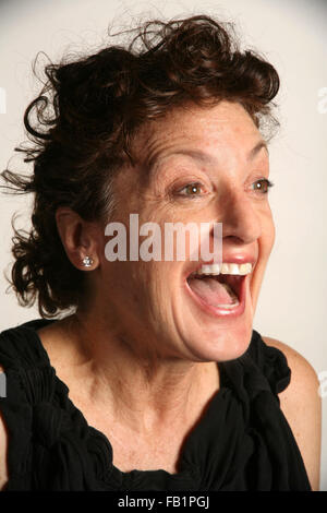 An adult woman imitates the expressions of a baby. Stock Photo