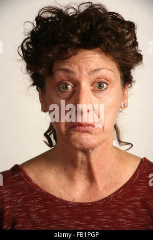 An adult woman imitates the expressions of a baby. Stock Photo