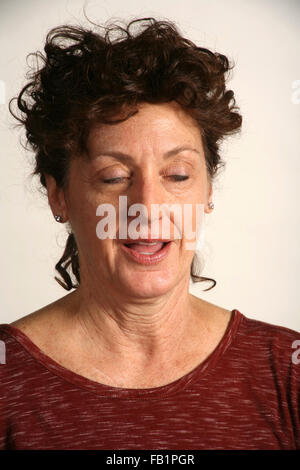 An adult woman imitates the expressions of a baby. Stock Photo