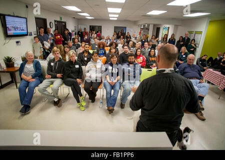 An attentive multiracial audience listens to a lecturer at a charity event for the homeless in Costa Mesa, CA. Stock Photo