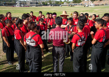 A Vietnamese-American high school marching band director leads his multiracial musicians in singing before a band competition in Mission Viejo, CA. Stock Photo