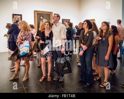 Museum visitors of many ages enjoy an exhibition of painter John Singer Sargent's work at the Metropolitan Museum of Art in New York City. Stock Photo