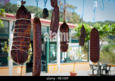 Big italian salami sausage hanging on string Stock Photo