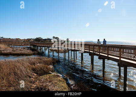 Two men walking on the Duck Soundside Boardwalk in the Outer Banks of North Carolina. Stock Photo