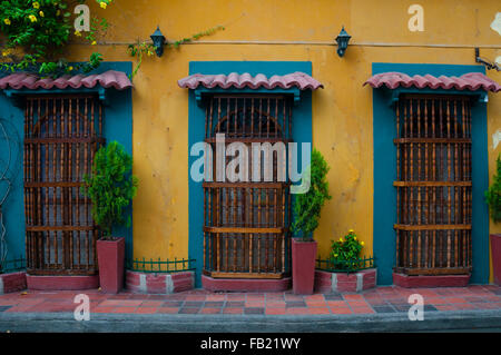 Yellow colonial house front with three doors Stock Photo