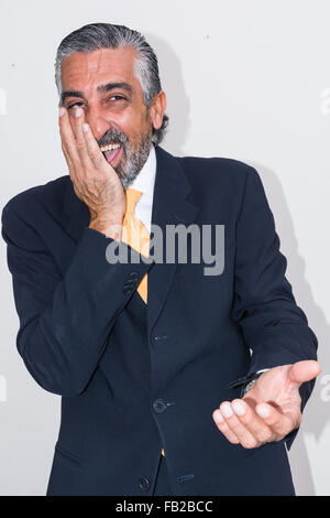 Adult man, mature, in suits. Bearded, grizzled, he thinks, deep in thought. Facial expressions, making faces. Stock Photo