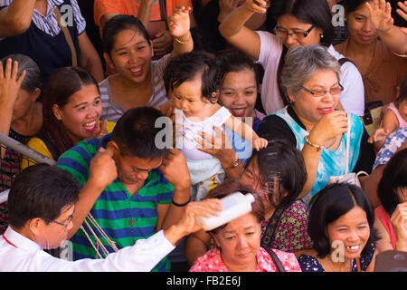 Cebu City,Philippines 08/01/2016. A Roman Catholic Solemn Mass held in the  Basilica Minore del St.Nino on the second day of the Fiesta Señor (Sinulog). A nine day religious festival honouring the Santo Nino De Cebu (Holy Child of Cebu). Many devotees bring with them a Santo Nino figurine representing the Child Jesus. Stock Photo