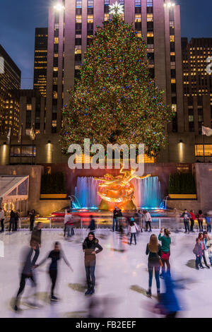 Lower Plaza of Rockefeller Center with ice skating rink and Christmas tree by night, Manhattan, New York, USA Stock Photo