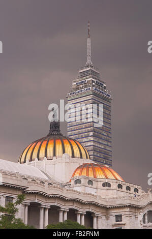 The domes of the Palacio de Bellas Artes in the foreground with a dramatic stormy sky in Mexico City, Mexico, South America Stock Photo