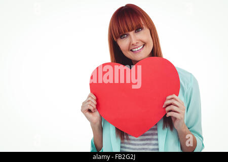 Smiling hipster woman behind a big red heart Stock Photo