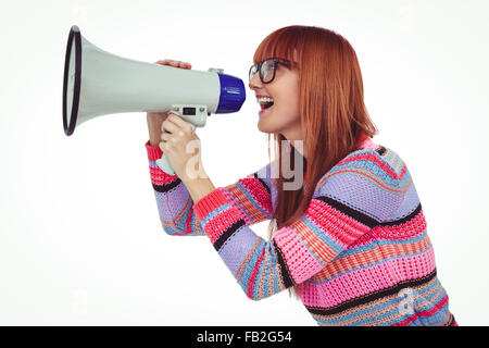 Smiling hipster woman shooting through megaphone Stock Photo