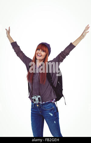 Smiling hipster woman with hands up Stock Photo