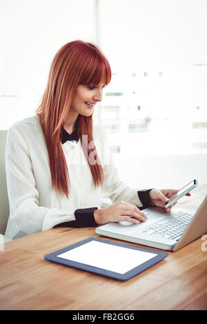 Mid section of a hipster businesswoman using her devices Stock Photo