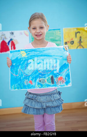 Cute girl showing her drawing Stock Photo - Alamy