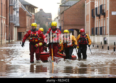 Rescue workers wade through high flood water in York, Yorkshire, UK, after both the River Ouse and Foss burst their banks. Stock Photo