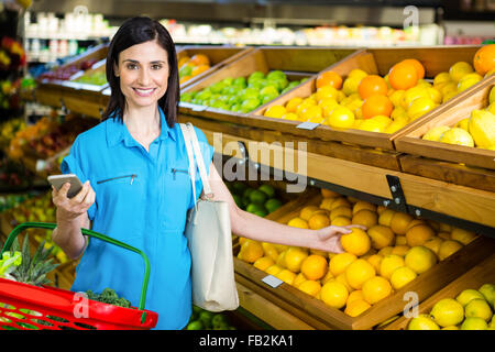 Portrait of a smiling woman picking orange Stock Photo