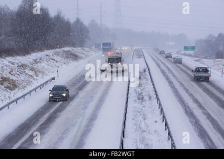 Sweden Weather: E20, Floda, Sweden, 8th Feb 2016. First major snowfall of the year causes traffic accidents and widespread travel disruptions. Snowplows and gritters are deployed to keep E20 motorway open.  Model Release: No.  Property Release: No. Stock Photo