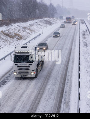 Sweden Weather: E20, Floda, Sweden, 8th Feb 2016. First major snowfall of the year causes traffic accidents and widespread travel disruptions. Snowplows and gritters are deployed to keep E20 motorway open.  Model Release: No.  Property Release: No. Stock Photo