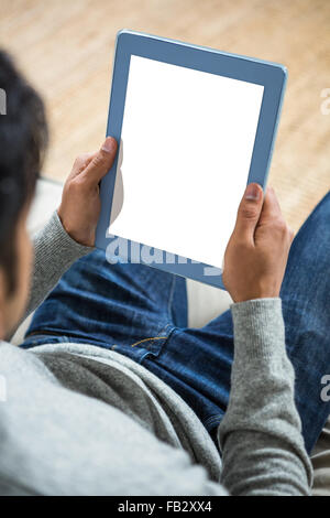 Handsome man using tablet on the sofa Stock Photo