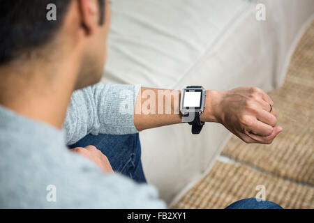 Handsome man using smartwatch Stock Photo