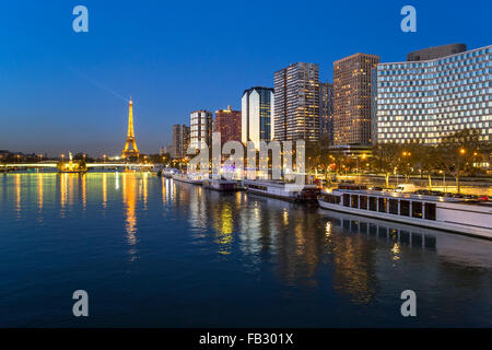 Night view of River Seine with boats and high-rise buildings on the Left Bank, and Eiffel Tower, Paris, France, Europe Stock Photo