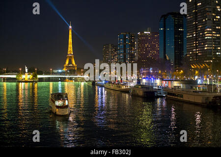 Night view of River Seine with boats and high-rise buildings on the Left Bank, and Eiffel Tower, Paris, France, Europe