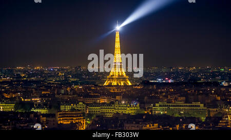 Paris elevated night city skyline over rooftops, the illuminated Eiffel tower, France, Europe Stock Photo