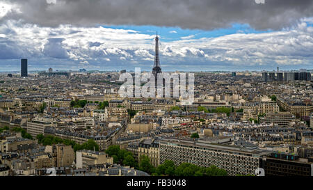 Eiffel Tower, elevated stormy city skyline viewed over rooftops, Paris, France, Europe Stock Photo